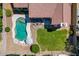 Overhead shot of a backyard featuring a pool, lawn, patio, and fire pit at 7236 W Aurora Dr, Glendale, AZ 85308