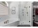 This bathroom boasts a soaking tub and glass enclosed shower featuring beautiful gold finish fixtures at 7236 W Aurora Dr, Glendale, AZ 85308