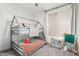 Cheerful bedroom features a bunk bed, an easel, and a collection of books at 7236 W Aurora Dr, Glendale, AZ 85308