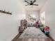 Bright playroom with a decorative rug, toy organizers, and a large window for natural light at 7236 W Aurora Dr, Glendale, AZ 85308