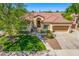 Charming home with a tile roof, landscaped front yard, and inviting entry with seating area at 7236 W Aurora Dr, Glendale, AZ 85308