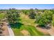 Lush green space with mature trees and walking path, offering a tranquil community setting at 7236 W Aurora Dr, Glendale, AZ 85308