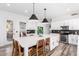 Bright, modern kitchen with stainless steel appliances, breakfast bar and eat-in dining space at 7236 W Aurora Dr, Glendale, AZ 85308