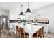 Spacious kitchen with a large center island, stainless steel appliances, white cabinets, and modern pendant lights at 7236 W Aurora Dr, Glendale, AZ 85308
