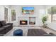 Cozy living room featuring a modern fireplace and wall-mounted television for comfortable living at 7236 W Aurora Dr, Glendale, AZ 85308