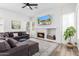 Comfortable living area with a fireplace, a large sectional sofa, and a wall-mounted TV at 7236 W Aurora Dr, Glendale, AZ 85308