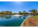 Scenic pond featuring a fountain and mature trees, creating a peaceful community setting at 7236 W Aurora Dr, Glendale, AZ 85308