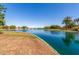 Beautiful community pond featuring a fountain and serene waterfront views with mature trees at 7236 W Aurora Dr, Glendale, AZ 85308