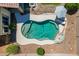 Aerial view of a private pool with lounge chairs and an umbrella at 7236 W Aurora Dr, Glendale, AZ 85308