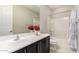 Bathroom featuring a single sink vanity, mirror and a shower with a tub at 7251 E Portobello Ave, Mesa, AZ 85212