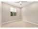 Bright bedroom with neutral carpet, a window with blinds, and light gray paint at 7251 E Portobello Ave, Mesa, AZ 85212