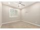 Neutral bedroom with a ceiling fan, a window and carpeted floor at 7251 E Portobello Ave, Mesa, AZ 85212