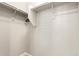 Walk-in closet with built-in shelves and hanging rods for optimal storage at 7251 E Portobello Ave, Mesa, AZ 85212