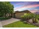 Charming single-story home with lush landscaping, inviting curb appeal, and a two-car garage at 7251 E Portobello Ave, Mesa, AZ 85212