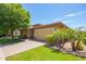 Lovely single-story home with desert landscaping, a paved driveway, and a two-car garage at 7251 E Portobello Ave, Mesa, AZ 85212