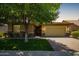 Charming single-story home with a lush green lawn, mature tree, and a two-car garage at 7251 E Portobello Ave, Mesa, AZ 85212