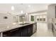 Open kitchen boasts granite counters, stainless appliances, island with sink, and a view to the living room at 7251 E Portobello Ave, Mesa, AZ 85212