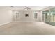 Large living room with neutral carpet, recessed lighting, and sliding doors to the backyard at 7251 E Portobello Ave, Mesa, AZ 85212
