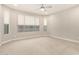 Spacious main bedroom with neutral carpeting, ceiling fan, and bright natural light at 7251 E Portobello Ave, Mesa, AZ 85212