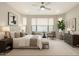 Spacious main bedroom featuring neutral tones, comfortable seating, and plenty of natural light at 7251 E Portobello Ave, Mesa, AZ 85212