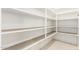Walk-in pantry with white shelving and tiled floor provides ample storage space at 7251 E Portobello Ave, Mesa, AZ 85212