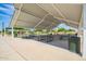 A covered community picnic area features multiple tables and nearby trash receptacles at 7251 E Portobello Ave, Mesa, AZ 85212