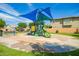 A modern community playground has a slide, play area and shade structure at 7251 E Portobello Ave, Mesa, AZ 85212