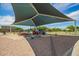 A playground is covered with shade and features modern play equipment at 7251 E Portobello Ave, Mesa, AZ 85212