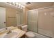 Well-lit bathroom with a vanity sink, toilet, and a bathtub-shower combination with sliding glass doors at 7436 E Chaparral Rd # B246, Scottsdale, AZ 85250