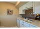 Functional kitchen with white cabinets and countertops, featuring a sink with a view to the dining area at 7436 E Chaparral Rd # B246, Scottsdale, AZ 85250