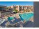 Beautiful community pool and hot tub area surrounded by well-maintained landscaping and lounge chairs at 7436 E Chaparral Rd # B246, Scottsdale, AZ 85250