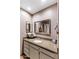 Updated bathroom featuring a granite countertop, one sink, a framed mirror, and linen cabinet at 7512 N Via Camello Del Sur --, Scottsdale, AZ 85258