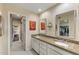 Bathroom with double sinks, granite countertop, linen cabinets, and framed mirrors at 7512 N Via Camello Del Sur --, Scottsdale, AZ 85258