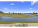 Expansive view of the lush golf course, pond, and distant residential area at 7512 N Via Camello Del Sur --, Scottsdale, AZ 85258
