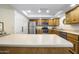 Bright kitchen featuring stainless steel appliances, wood cabinets, and a large island counter at 7512 N Via Camello Del Sur --, Scottsdale, AZ 85258