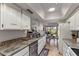 Modern kitchen featuring granite counters, stainless steel appliances, and a pass-through to dining area at 7512 N Via Camello Del Sur --, Scottsdale, AZ 85258