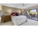 Bright main bedroom featuring a ceiling fan, neutral carpet, and a sliding glass door to an outdoor seating area at 7512 N Via Camello Del Sur --, Scottsdale, AZ 85258