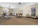 Inviting meeting room with tables, chairs, a bookshelf and large windows for natural light at 7512 N Via Camello Del Sur --, Scottsdale, AZ 85258