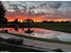 Scenic view of a pond reflecting a vibrant sunset sky on the golf course at 7512 N Via Camello Del Sur --, Scottsdale, AZ 85258