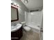A bright bathroom featuring a bath and shower combination, toilet, and charming cherry-stained vanity at 8103 E Southern Ave # 279, Mesa, AZ 85209