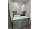 Convenient laundry room featuring washer and dryer hookups and upper cabinets for storage at 8103 E Southern Ave # 279, Mesa, AZ 85209