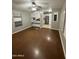 Inviting living room with wood flooring, ceiling fan, and view of the open kitchen at 8103 E Southern Ave # 279, Mesa, AZ 85209