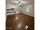 Open living room featuring wood floors, a ceiling fan, and open to the kitchen at 8103 E Southern Ave # 279, Mesa, AZ 85209