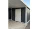 Exterior shot of the shed with a white door, matching the trim on the gray siding at 8103 E Southern Ave # 279, Mesa, AZ 85209