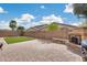 Backyard featuring a paved patio, built-in fireplace, artificial turf, and privacy wall at 9165 W Mine Trl, Peoria, AZ 85383