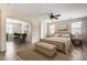 Spacious bedroom featuring a ceiling fan, ensuite sitting room, and lots of natural light from two windows at 9165 W Mine Trl, Peoria, AZ 85383