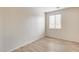 The bedroom has neutral walls, laminate floors, a window for natural light and electrical outlets at 9165 W Mine Trl, Peoria, AZ 85383