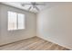 Bedroom featuring light hardwood floors and a window offering natural light at 9165 W Mine Trl, Peoria, AZ 85383