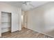 Bedroom showcasing light hardwood floors, a closet, and an open doorway at 9165 W Mine Trl, Peoria, AZ 85383