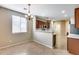 Open-concept dining area features wood-look floors and a chandelier, flowing into the kitchen, ideal for gatherings at 9165 W Mine Trl, Peoria, AZ 85383